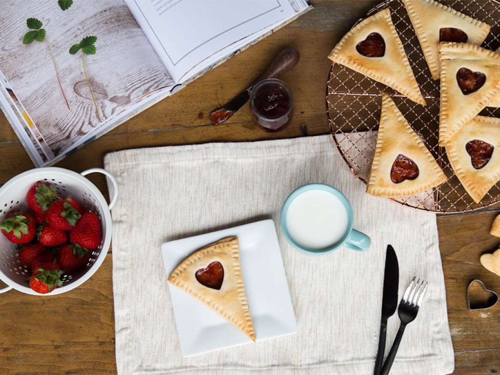 Aerial view of homepage poptarts on partment paper with a heart shaped cut out in the middle.