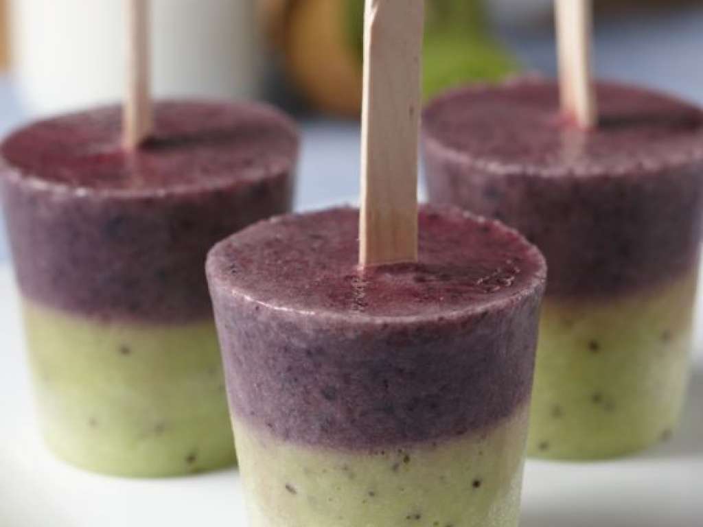 Close up of three green and purple homemade popsicles.