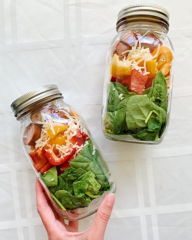 two jars with salad stacked inside