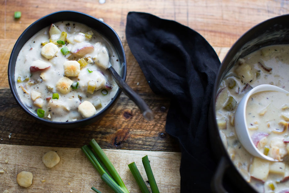 black bowl with New England Clam chowder and chunks vegetables