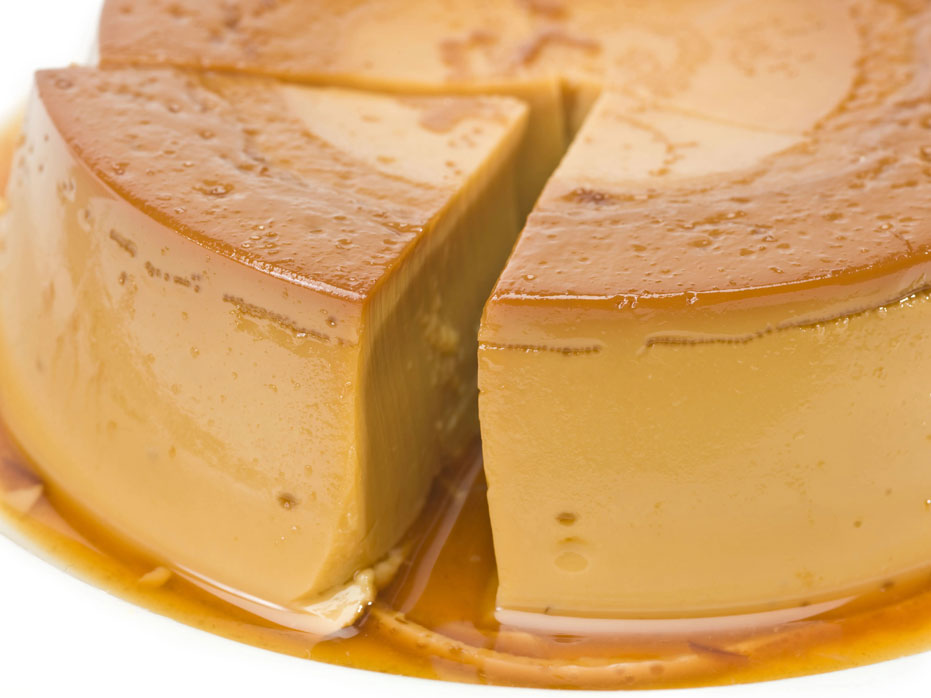 platter of flan with a slice partially removed.