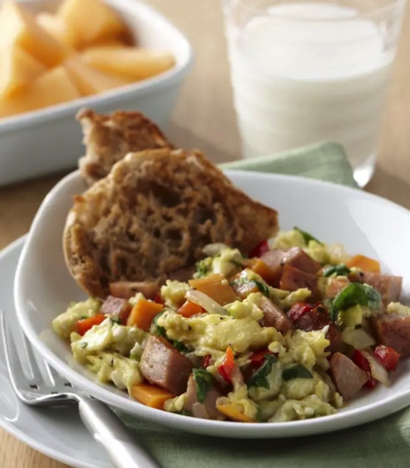 egg scramble with meat and vegetables with a side of english muffin