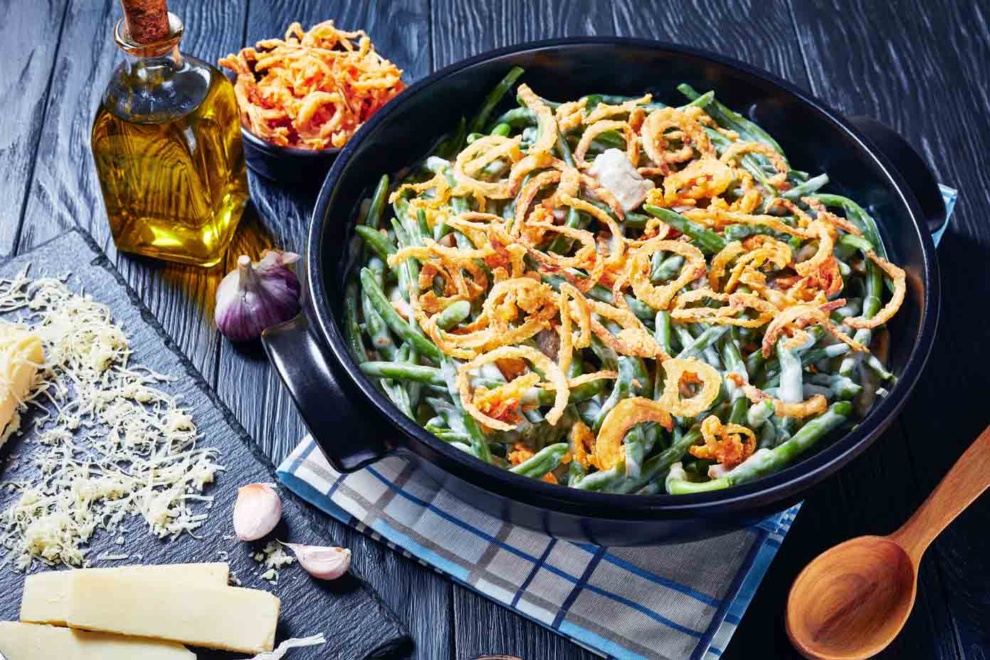 green bean casserole with fried onions on top in a cast iron skillet