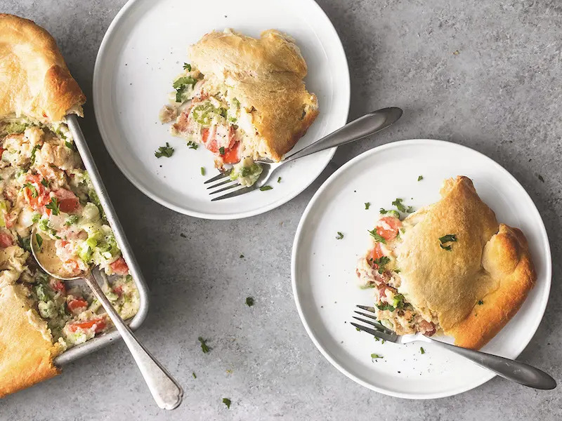 aerial shot of slice of chicken pot pie on a white plate