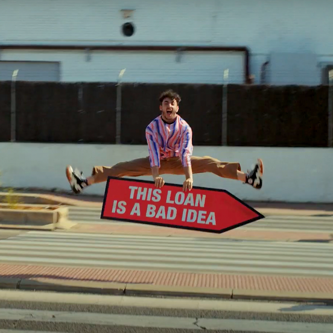 image of guy holding sign jumping in a split